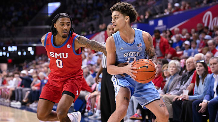 Jan 3, 2026; Dallas, Texas, USA; North Carolina Tar Heels guard Kyan Evans (0) looks to move the ball past SMU Mustangs guard B.J. Edwards (0) during the game between the Mustangs and the Tar Heels at Moody Coliseum. Mandatory Credit: Jerome Miron-Imagn Images Jan 3, 2026; Dallas, Texas, USA; North Carolina Tar Heels guard Kyan Evans (0) looks to move the ball past SMU Mustangs guard B.J. Edwards (0) during the game between the Mustangs and the Tar Heels at Moody Coliseum. Mandatory Credit: Jerome Miron-Imagn Images
