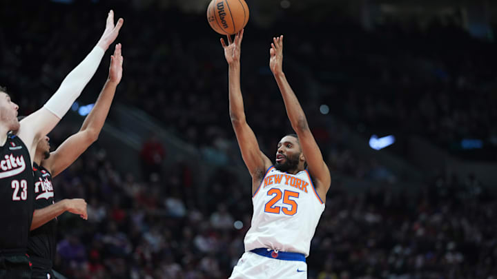 Mar 12, 2025; Portland, Oregon, USA; New York Knicks small forward Mikal Bridges (25) shoots the ball over Portland Trail Blazers center Donovan Clingan (23) and guard Rayan Rupert (21) during the second half at Moda Center. Mandatory Credit: Soobum Im-Imagn Images