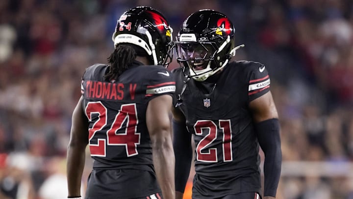 Oct 21, 2024; Glendale, Arizona, USA; Arizona Cardinals cornerback Garrett Williams (21) celebrates play with teammate Starling Thomas V (24) against the Los Angeles Chargers at State Farm Stadium. Mandatory Credit: Mark J. Rebilas-Imagn Images