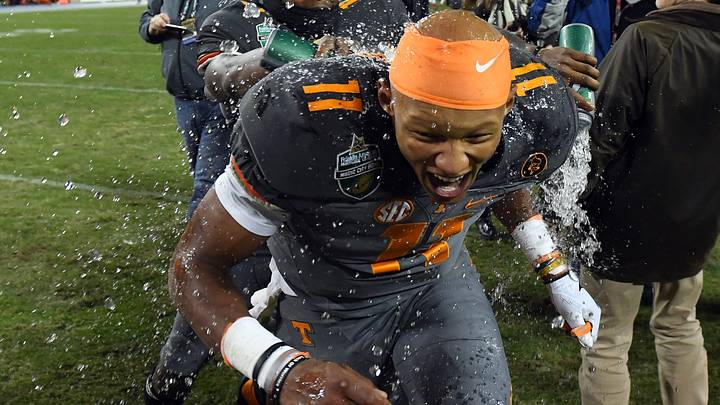 Dec 30, 2016; Nashville , TN, USA; Tennessee Volunteers quarterback Joshua Dobbs (11) is dumped with water by teammate quarterback Sheriron Jones (13) after a win over the Nebraska Cornhuskers at Nissan Stadium. Tennessee won 38-24. Mandatory Credit: Christopher Hanewinckel-USA TODAY Sports