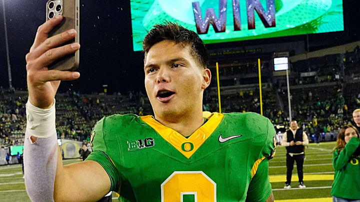Oregon quarterback Dillon Gabriel posts a video on social media on his way off the field after defeating Maryland at Autzen Stadium Saturday, Nov. 9, 2024.