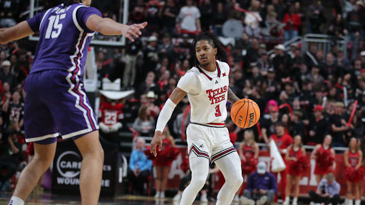 Jan 29, 2025; Lubbock, Texas, USA;  Texas Tech Red Raiders guard Elijah Hawkins (3) dribbles the ball against Texas Christian Horned Frogs forward David Punch (15) in the second half at United Supermarkets Arena. Mandatory Credit: Michael C. Johnson-Imagn Images