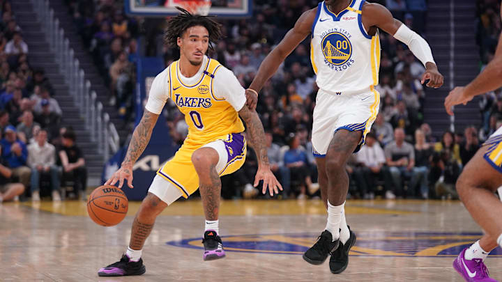 Los Angeles Lakers guard Jalen Hood-Schifino (0) dribbles the ball next to Golden State Warriors forward Jonathan Kuminga (00) in the first quarter at the Chase Center. Los Angeles Lakers guard Jalen Hood-Schifino (0) dribbles the ball next to Golden State Warriors forward Jonathan Kuminga (00) in the first quarter at the Chase Center.