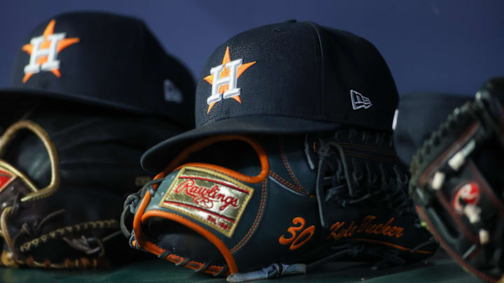 Apr 21, 2023; Atlanta, Georgia, USA; A detailed view of a Houston Astros hat and glove in the dugout against the Atlanta Braves in the fifth inning at Truist Park.