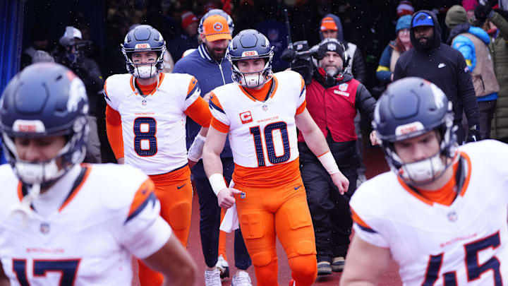 Jan 12, 2025; Orchard Park, New York, USA; Denver Broncos quarterback Jarrett Stidham (8) and quarterback Bo Nix (10) warm up before a game against the Buffalo Bills in an AFC wild card game at Highmark Stadium. 