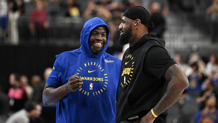 Oct 15, 2024; Las Vegas, Nevada, USA; Golden State Warriors forward Draymond Green (23) and Los Angeles Lakers forward LeBron James (23) talk on court before warm up at T-Mobile Arena. Mandatory Credit: Candice Ward-Imagn Images