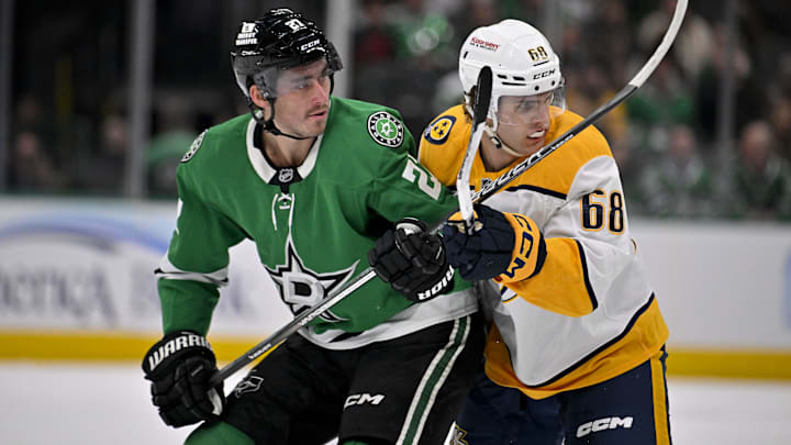Dec 12, 2024; Dallas, Texas, USA;  Dallas Stars left wing Mason Marchment (27) and Nashville Predators left wing Zachary L'Heureux (68) look for the puck at center ice during the first period at the American Airlines Center. Mandatory Credit: Jerome Miron-Imagn Images