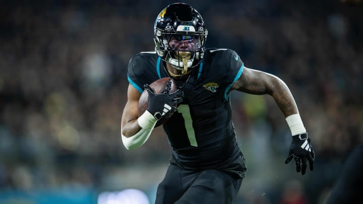 Dec 4, 2023; Jacksonville, Florida, USA; Jacksonville Jaguars running back Travis Etienne Jr. (1) runs for a touchdown against the Cincinnati Bengals in the first quarter at EverBank Stadium.