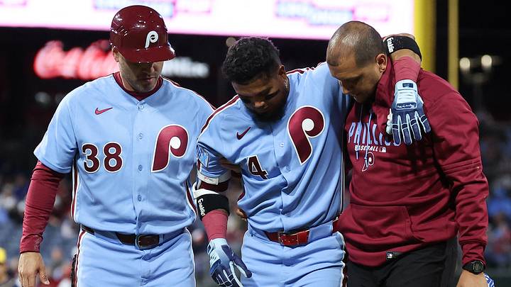 Sep 24, 2026; Philadelphia, Pennsylvania, USA; Philadelphia Phillies second baseman Luis Arraez (4) is helped off the field by trainer Christian Bermudez and first base coach Paco Figueroa (38) after being injured during the sixth inning against the Milwaukee Brewers at Citizens Bank Park. Mandatory Credit: Bill Streicher-Imagn Images
