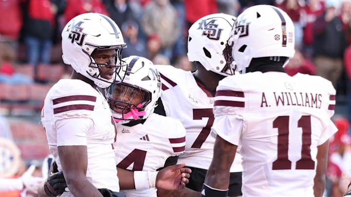 Mississippi State Bulldogs quarterback Kamario Taylor (1) celebrates with teammates after scoring a touchdown during the third quarter against the Arkansas Razorbacks at Donald W. Reynolds Razorback Stadium. Bulldogs won 38-35. 
