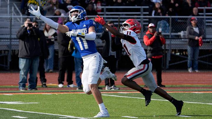 Detroit Catholic Central (11) Gideon Gash stretches out on a ball thrown too high for him as East Kentwood (11) Stephan Jones defends during the first half of the MHSAA Division 1 football semifinals between Detroit Catholic Central and East Kentwood et Jackson High School in Jackson on Saturday, Nov. 22, 2025,