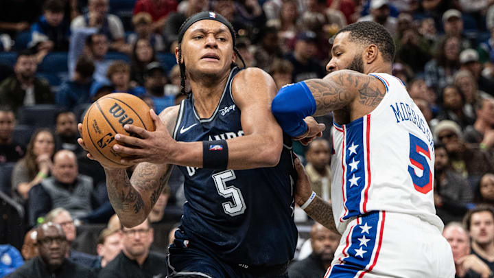Dec 27, 2023; Orlando, Florida, USA; Orlando Magic forward Paolo Banchero (5) drives to the basket against Philadelphia 76ers small forward Marcus Morris Sr. (5) in the fourth quarter at Kia Center. Mandatory Credit: Jeremy Reper-Imagn Images