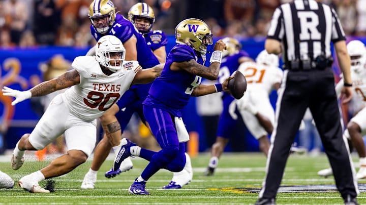 Jan 1, 2024; New Orleans, LA, USA; Washington Huskies quarterback Michael Penix Jr. (9) tries to