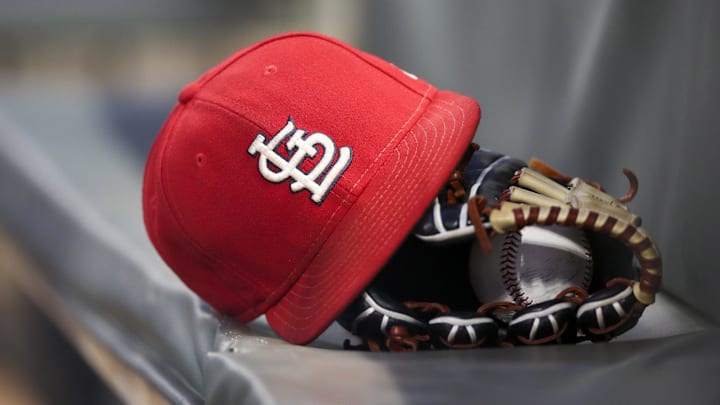 Sep 17, 2018; Atlanta, GA, USA; Detailed view of a St. Louis Cardinals hat and glove in the dugout against the Atlanta Braves in the first inning at SunTrust Park. Mandatory Credit: Brett Davis-Imagn Images
