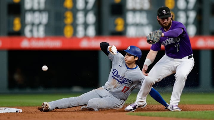 Sep 27, 2024; Denver, Colorado, USA; Los Angeles Dodgers designated hitter Shohei Ohtani (17) steals second as Colorado Rockies second baseman Brendan Rodgers (7) is unable to field the throw in the second inning at Coors Field. Mandatory Credit: Isaiah J. Downing-Imagn Images Sep 27, 2024; Denver, Colorado, USA; Los Angeles Dodgers designated hitter Shohei Ohtani (17) steals second as Colorado Rockies second baseman Brendan Rodgers (7) is unable to field the throw in the second inning at Coors Field. Mandatory Credit: Isaiah J. Downing-Imagn Images
