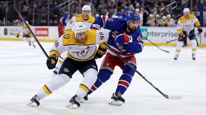 Mar 2, 2025; New York, New York, USA; Nashville Predators center Ryan O'Reilly (90) and New York Rangers defenseman Calvin de Haan (44) fight for position during the first period at Madison Square Garden. Mandatory Credit: Brad Penner-Imagn Images