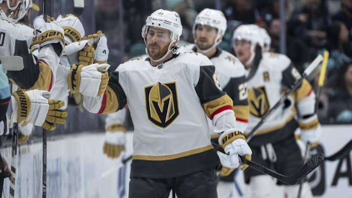 Mar 12, 2024; Seattle, Washington, USA; Vegas Golden Knights forward Jonathan Marchessault (81) is congratulated by teammates on then bench after scoring a power-play goal against the Seattle Kraken during the second period at Climate Pledge Arena. Mandatory Credit: Stephen Brashear-Imagn Images