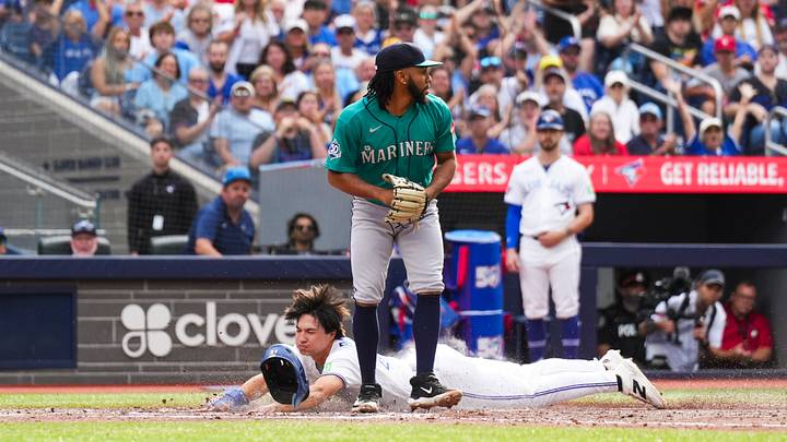 Aug 29, 2026; Toronto, Ontario, CAN; Toronto Blue Jays center fielder Brett Bateman (21) slides into home plate to score against the Seattle Mariners during the fifth inning at Rogers Centre. Mandatory Credit: Kevin Sousa-Imagn Images Aug 29, 2026; Toronto, Ontario, CAN; Toronto Blue Jays center fielder Brett Bateman (21) slides into home plate to score against the Seattle Mariners during the fifth inning at Rogers Centre. Mandatory Credit: Kevin Sousa-Imagn Images