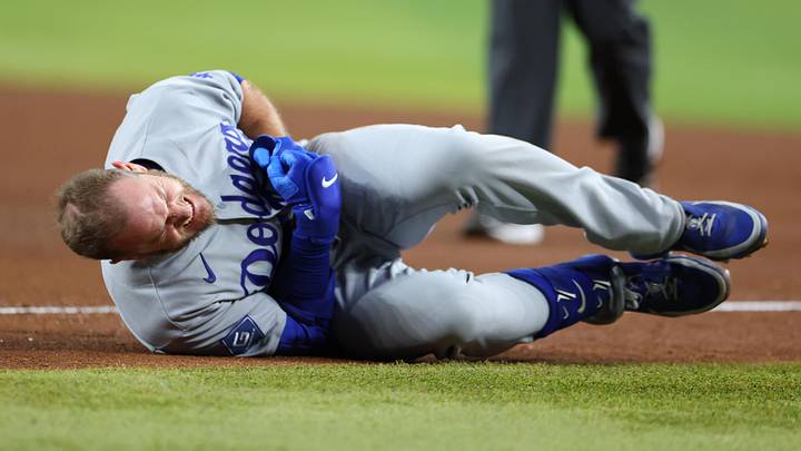 Jun 4, 2026; Phoenix, Arizona, USA; Los Angeles Dodgers third baseman Max Muncy (13) reacts with an apparent injury after colliding with Arizona Diamondbacks first baseman Ildemaro Vargas (not pictured) at first base in the fifth inning at Chase Field. Mandatory Credit: Anna Carrington-Imagn Images