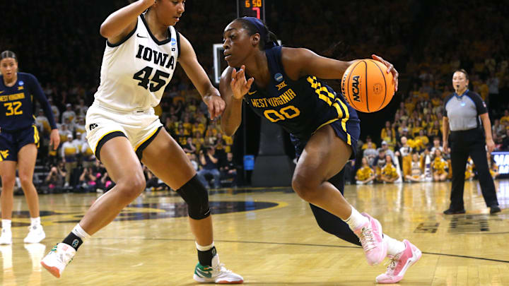 Iowa’s Hannah Stuelke (45) defends West Virginia’s Jayla Hemingway (00) in a NCAA Tournament round