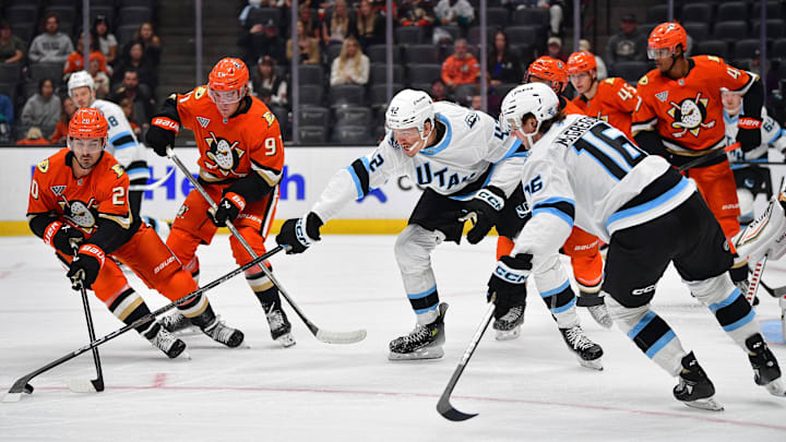 Sep 22, 2025; Anaheim, California, USA; Utah Mammoth center Curtis Douglas (42) plays for the puck against Anaheim Ducks left wing Chris Kreider (20) during the first period at Honda Center. Mandatory Credit: Gary A. Vasquez-Imagn Images