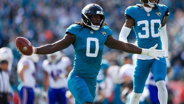Jacksonville Jaguars linebacker Devin Lloyd (0) celebrates a fumble recovery with cornerback Montaric Brown (30) during the second quarter of an NFL football AFC Wild Card playoff matchup, Sunday, Jan. 11, 2026, in Jacksonville, Fla. [Corey Perrine/Florida Times-Union]
