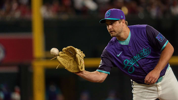 Aug 23, 2025; Phoenix, Arizona, USA; Arizona Diamondbacks starting pitcher Jalen Beeks (68) reaches out to grab a ball while on the mound in the first inning against the Cincinnati Reds at Chase Field. Mandatory Credit: Allan Henry-Imagn Images Aug 23, 2025; Phoenix, Arizona, USA; Arizona Diamondbacks starting pitcher Jalen Beeks (68) reaches out to grab a ball while on the mound in the first inning against the Cincinnati Reds at Chase Field. Mandatory Credit: Allan Henry-Imagn Images