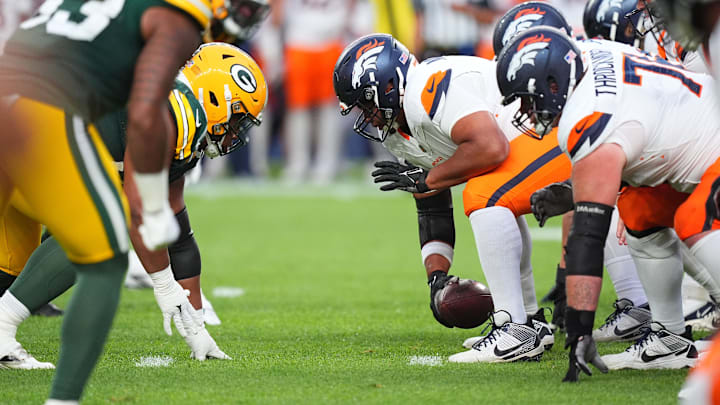 Aug 18, 2024; Denver, Colorado, USA; Denver Broncos center Sam Mustipher (61) snaps the ball in the second quarter against the Green Bay Packers at Empower Field at Mile High. Mandatory Credit: Ron Chenoy-Imagn Images