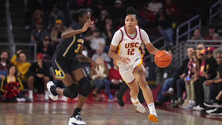Dec 29, 2024; Los Angeles, California, USA; Southern California Trojans guard JuJu Watkins (12) dribbles the ball against Michigan Wolverines guard Te'Yala Delfosse (33) in the first half at Galen Center. Mandatory Credit: Kirby Lee-Imagn Images