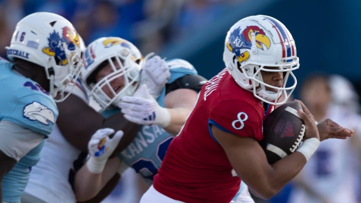 Kansas freshman quarterback Isaiah Marshall (8) breaks through the defense during Friday's Spring Preview at Rock Chalk Park.