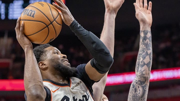 Mar 25, 2025; Detroit, Michigan, USA; Detroit Pistons guard Malik Beasley (5) drives to the basket as San Antonio Spurs forward Sandro Mamukelashvili (54) defends during the first half at Little Caesars Arena. Mandatory Credit: David Reginek-Imagn Images