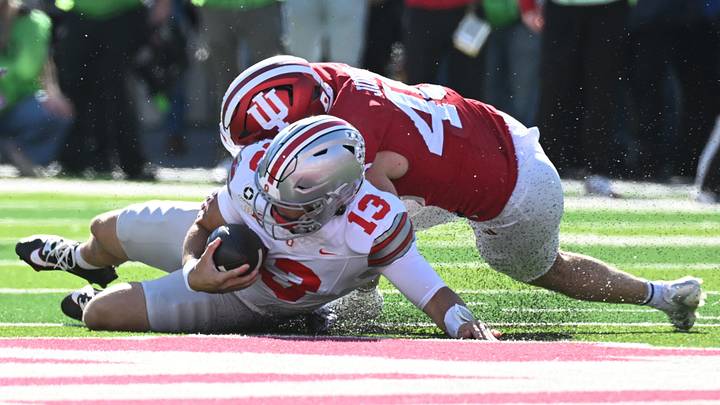 Oct 17, 2026; Bloomington, Indiana, USA;  Ohio State Buckeyes quarterback Luke Fahey (13) is tackled by Indiana Hoosiers linebacker Isaiah Jones (46) during the second half at Merchants Bank Field at Memorial Stadium.  Mandatory Credit: Robert Goddin-Imagn Images