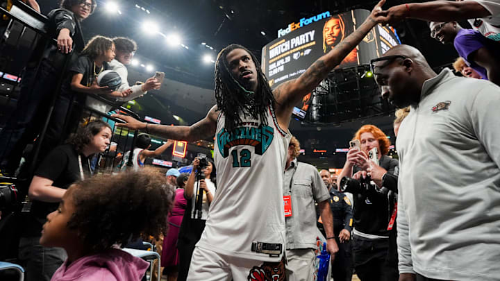 Grizzlies' Ja Morant (12) high fives fans as he walks off the court after the Grizzlies defeated the Mavericks 120-106 in the play-in game to secure a spot in the NBA Playoffs at FedExForum in Memphis, Tenn., on Friday, April 18, 2025.