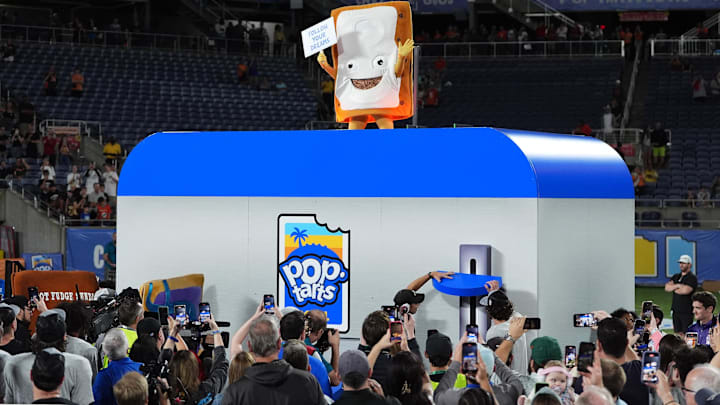 Dec 28, 2024; Orlando, FL, USA; The Cinnamon Pop-Tart mascot goes into a toaster to be toasted after the Iowa State Cyclones defeatied the Miami Hurricanes at Camping World Stadium. Mandatory Credit: Jasen Vinlove-Imagn Images