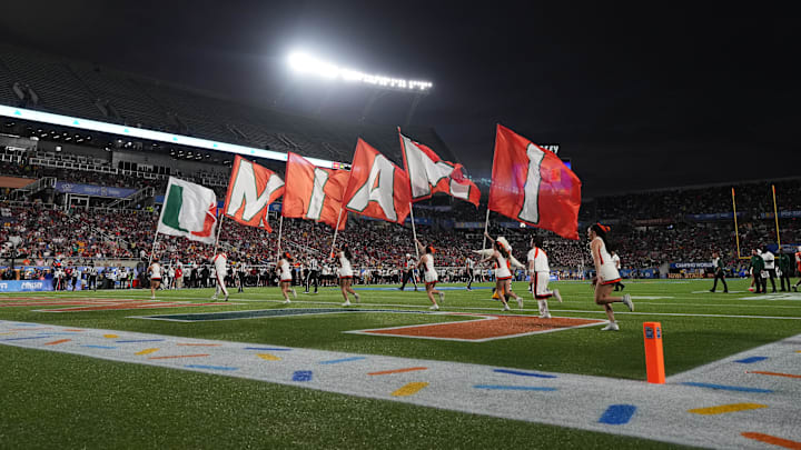 Miami Hurricanes cheerleaders run on the field with flags after a touchdown against the Iowa State Cyclones during the second half at Camping World Stadium. 