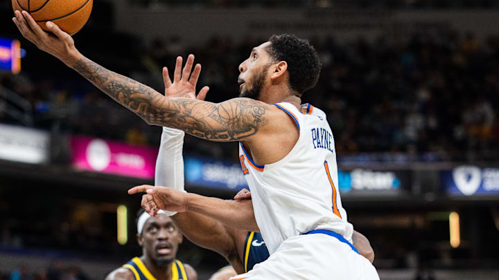 Feb 11, 2025; Indianapolis, Indiana, USA; New York Knicks guard Cameron Payne (1) shoots the ball while Indiana Pacers forward Jarace Walker (5) defends in the second half at Gainbridge Fieldhouse. Mandatory Credit: Trevor Ruszkowski-Imagn Images