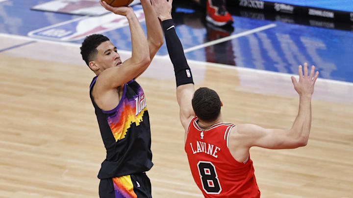 Phoenix Suns guard Devin Booker (1) shoots against Chicago Bulls guard Zach LaVine (8) during the first half of an NBA game at United Center. Mandatory Credit: Kamil Krzaczynski-Imagn Images