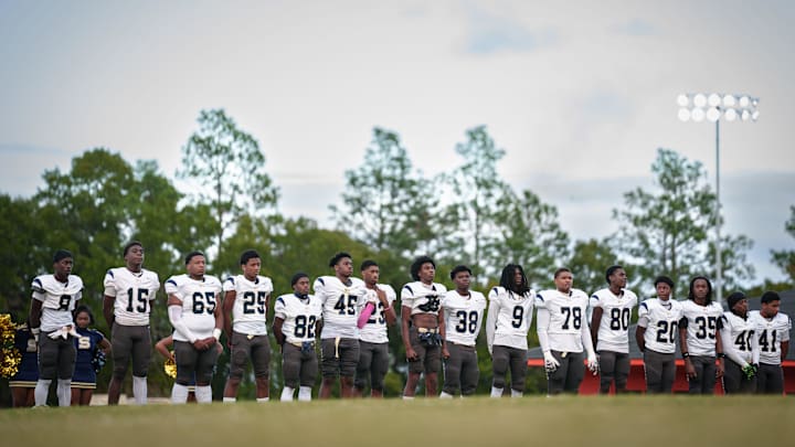 The E.E. Smith football team stands in the end zone during a special tribute honoring the lives of the three E.E. Smith High School football players, Trevor Merritt, Jai'Hyon Elliott and Nicholas Williams before Tuesday night’s game at South View High School. Students, families, and local leaders came together to honor the three that were killed in a car accident last week.