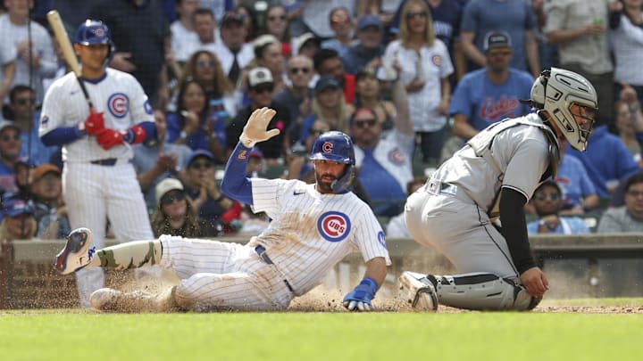Chicago Cubs shortstop Dansby Swanson (7) scores against the Chicago White Sox at Wrigley Field. 