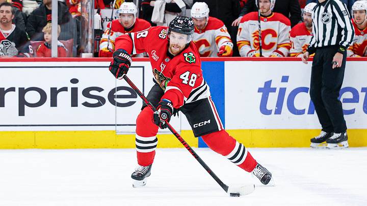 Jan 15, 2026; Chicago, Illinois, USA; Chicago Blackhawks defenseman Matt Grzelcyk (48) passes the puck against the Calgary Flames during the first period at United Center. Mandatory Credit: Kamil Krzaczynski-Imagn Images