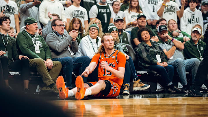 Illinois forward Jake Davis (15) hits the deck during the Illini's 85-82 loss to Michigan State on Saturday in East Lansing, Michigan.