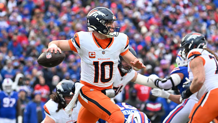 Jan 12, 2025; Orchard Park, New York, USA; Denver Broncos quarterback Bo Nix (10) throws downfield during the second quarter against the Buffalo Bills in an AFC wild card game at Highmark Stadium.