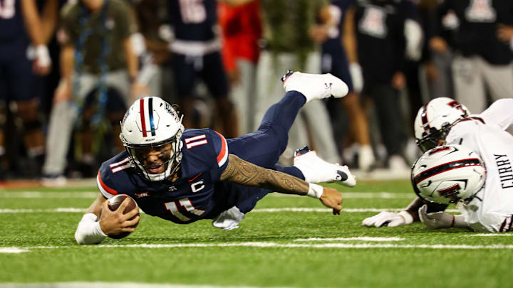 Oct 5, 2024; Tucson, Arizona, USA; Arizona Wildcats quarterback Noah Fifita (11) dives for a first down against Texas Tech Red Raiders during third quarter at Arizona Stadium. Oct 5, 2024; Tucson, Arizona, USA; Arizona Wildcats quarterback Noah Fifita (11) dives for a first down against Texas Tech Red Raiders during third quarter at Arizona Stadium.