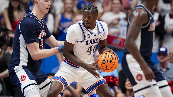 Feb 7, 2026; Lawrence, Kansas, USA; Kansas Jayhawks forward Flory Bidunga (40) drives against Arizona Wildcats center Motiejus Krivas (13) during the first half at Allen Fieldhouse. Mandatory Credit: Jay Biggerstaff-Imagn Images