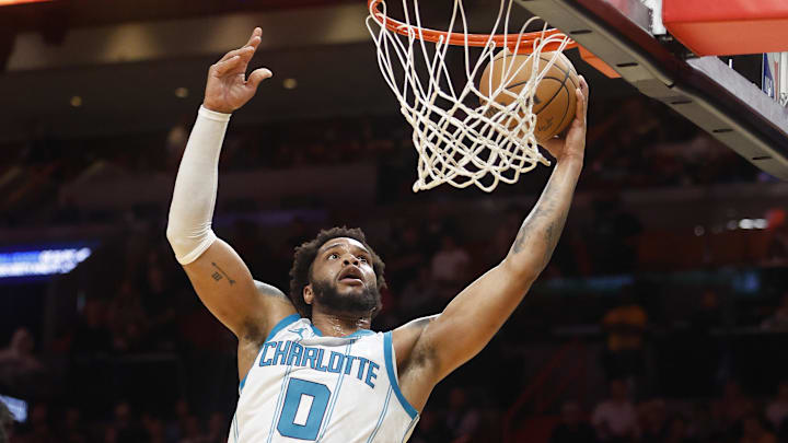 Mar 10, 2025; Miami, Florida, USA;  Charlotte Hornets forward Miles Bridges (0) dunks against the Miami Heat during the first half at Kaseya Center. Mandatory Credit: Rhona Wise-Imagn Images