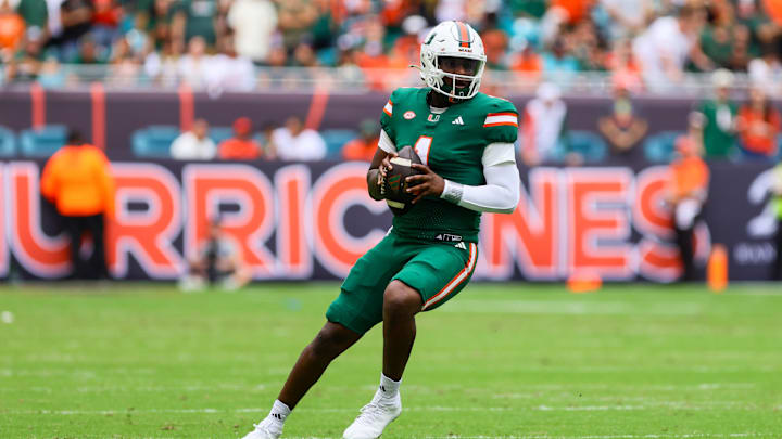 Nov 2, 2024; Miami Gardens, Florida, USA; Miami Hurricanes quarterback Cam Ward (1) looks for a passing option against the Duke Blue Devils during the first quarter at Hard Rock Stadium. Mandatory Credit: Sam Navarro-Imagn Images