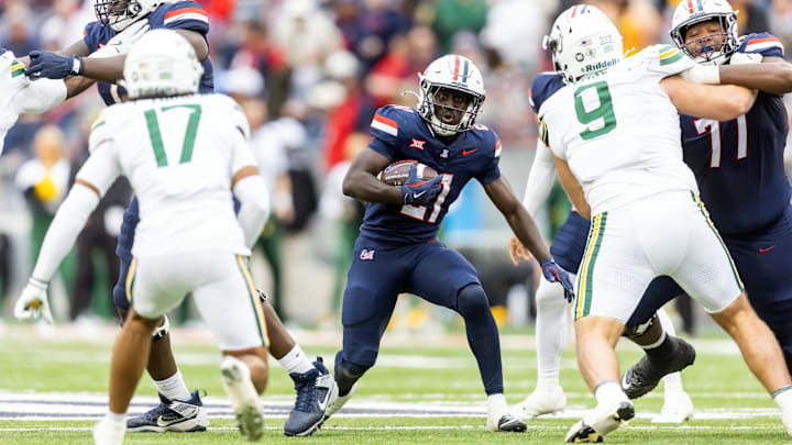 Nov 22, 2025; Tucson, Arizona, USA; Arizona Wildcats running back Ismail Mahdi (21) against the Baylor Bears at Casino Del Sol Stadium. Mandatory Credit: Mark J. Rebilas-Imagn Images
