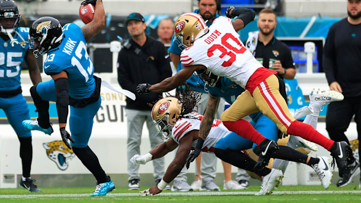 Jacksonville Jaguars wide receiver Christian Kirk (13) is forced out of bounds by San Francisco 49ers running back Jordan Mason (24) and safety George Odum (30) during the second quarter of an NFL football game Sunday, Nov. 12, 2023 at EverBank Stadium in Jacksonville, Fla. The San Francisco 49ers defeated the Jacksonville Jaguars 34-3. [Corey Perrine/Florida Times-Union]
