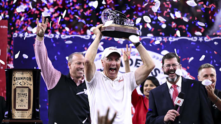 Dec 27, 2025; Houston, TX, USA; Houston Cougars head coach Willie Fritz hoists the champions trophy after the win over Louisiana State Tigers at NRG Stadium. 