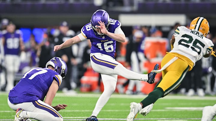 Dec 29, 2024; Minneapolis, Minnesota, USA; Minnesota Vikings place kicker Will Reichard (16) kicks an extra point as punter Ryan Wright (17) holds and Green Bay Packers cornerback Keisean Nixon (25) goes for the block during the third quarter at U.S. Bank Stadium. Dec 29, 2024; Minneapolis, Minnesota, USA; Minnesota Vikings place kicker Will Reichard (16) kicks an extra point as punter Ryan Wright (17) holds and Green Bay Packers cornerback Keisean Nixon (25) goes for the block during the third quarter at U.S. Bank Stadium.